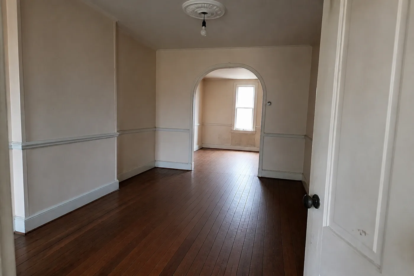 The same dining room with the floor flat, refinished in a warm walnut-toned satin